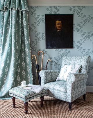 blue teal curtains with white floral pattern and white lace trim in living room with armchair