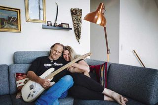 Walter Trout and wife Marie snuggle on a sofa