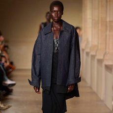 A Victoria Beckham runway model wearing a denim shacket. 