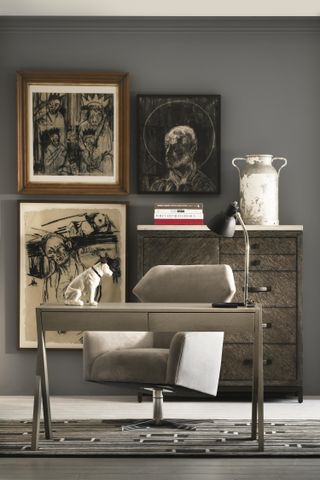 desk and chair in home office with artwork on the wall