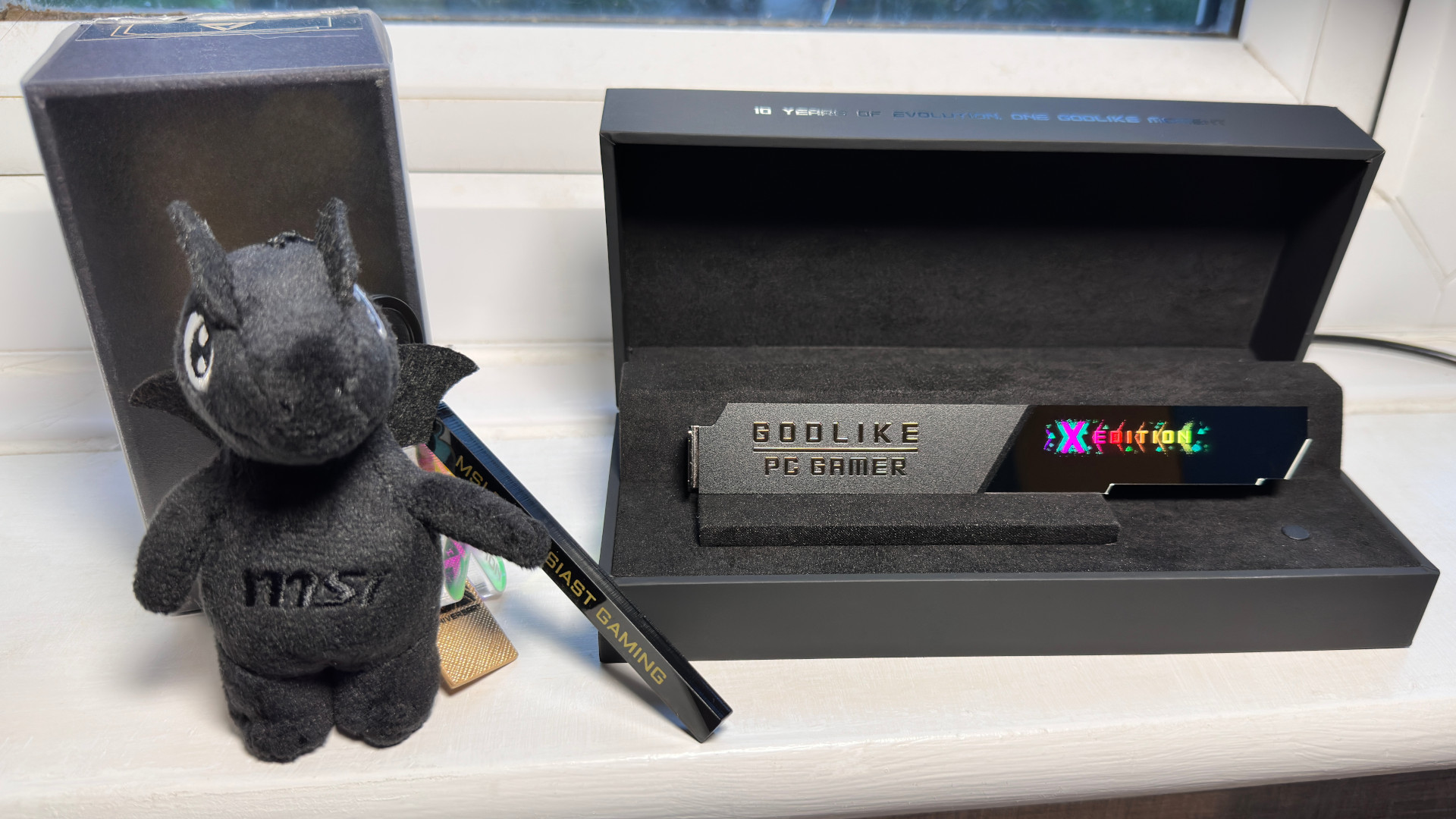 A photo of the unique physical items in MSI's MEG X870E Godlike X Edition motherboard