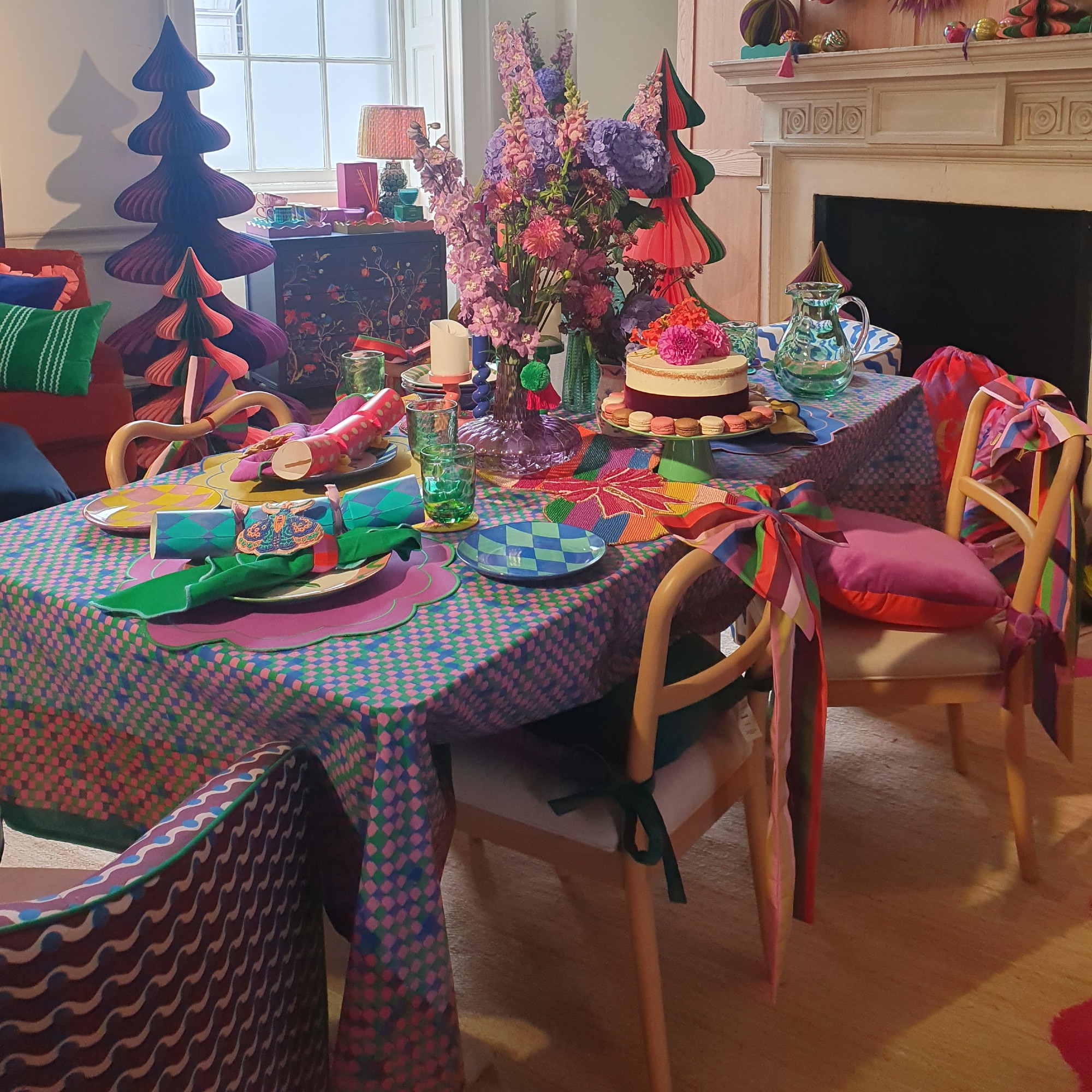 A colourfully decorated dining table for Christmas with harlequin plates at the Dunelm autumn/winter 2025 press show