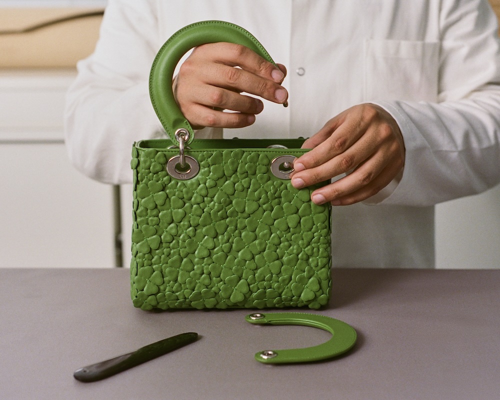 a Dior craftsman assembling a Dior lady clover bag