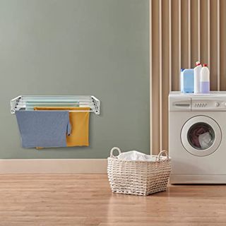 Laundry room with white wall mounted laundry rack