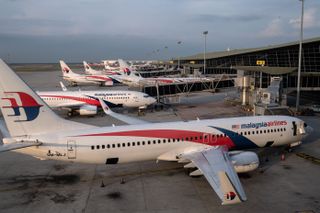 Malaysian Airlines aircraft lined up at an airport