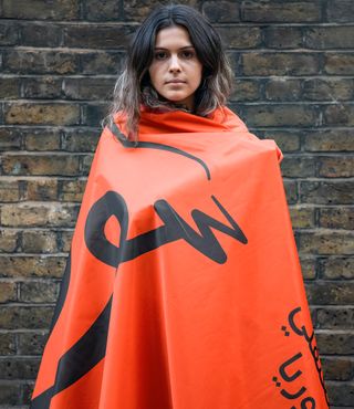 woman with red free Syria flag wrapped around her