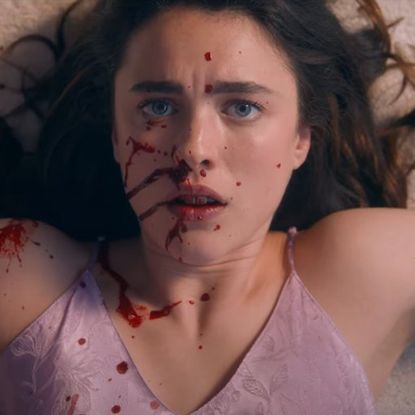 margaret qualley as sue with blood on her face in the substance