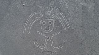 A processed image of a geoglyph featuring a person who appears to have long hair and arms that stick out in greater detail.