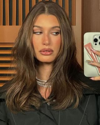 Hailey Bieber wearing Peptide Lip Tint in Toast