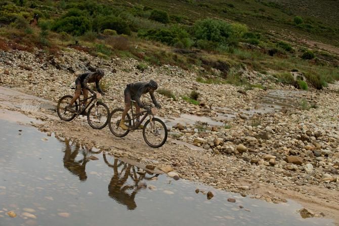 Kevin Evans and Max Knox of team Fedgroup Itec crossing a river