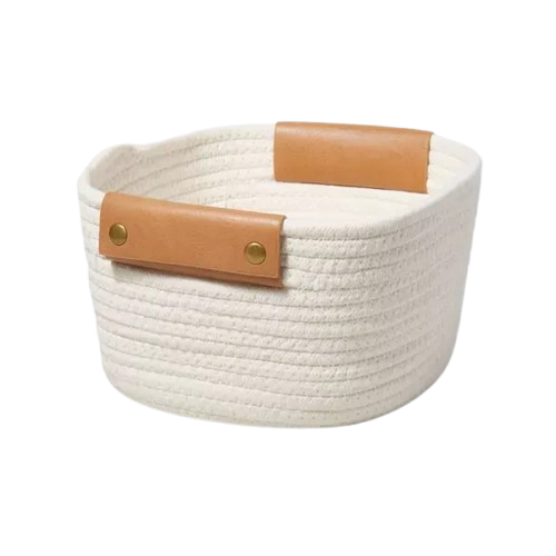 A cream rope coiled basket with leather handles