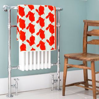 bathroom with radiator and wooden chair