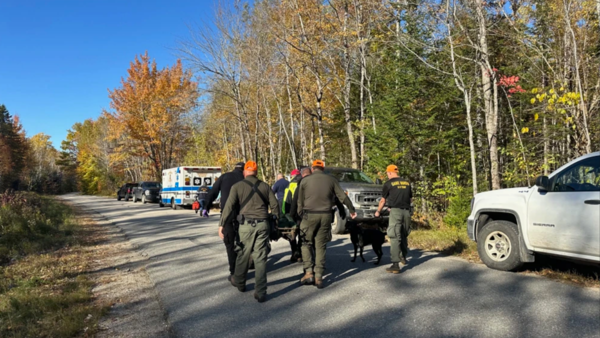 Maine rangers stretcher carry a patient to an ambulance