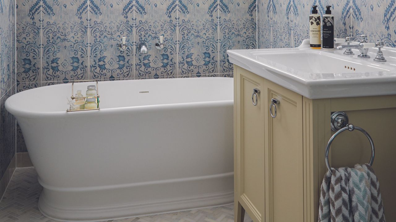 Bathroom with olive green cabinet and bath