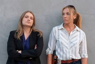 Unbelievable screengrab, of two women standing in front of a wall