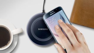 Samsung's Galaxy S6 being put onto a wireless charging pad.