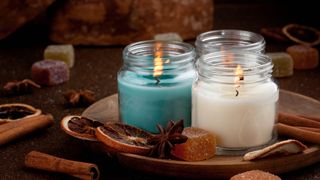 Three scented candles burning indoors