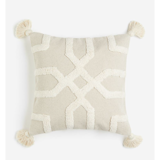 cream and beige pillow with a tufted geometric pattern