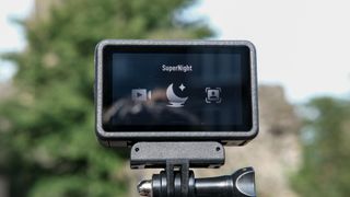 The DJI Osmo Action 5 Pro against an outdoors background