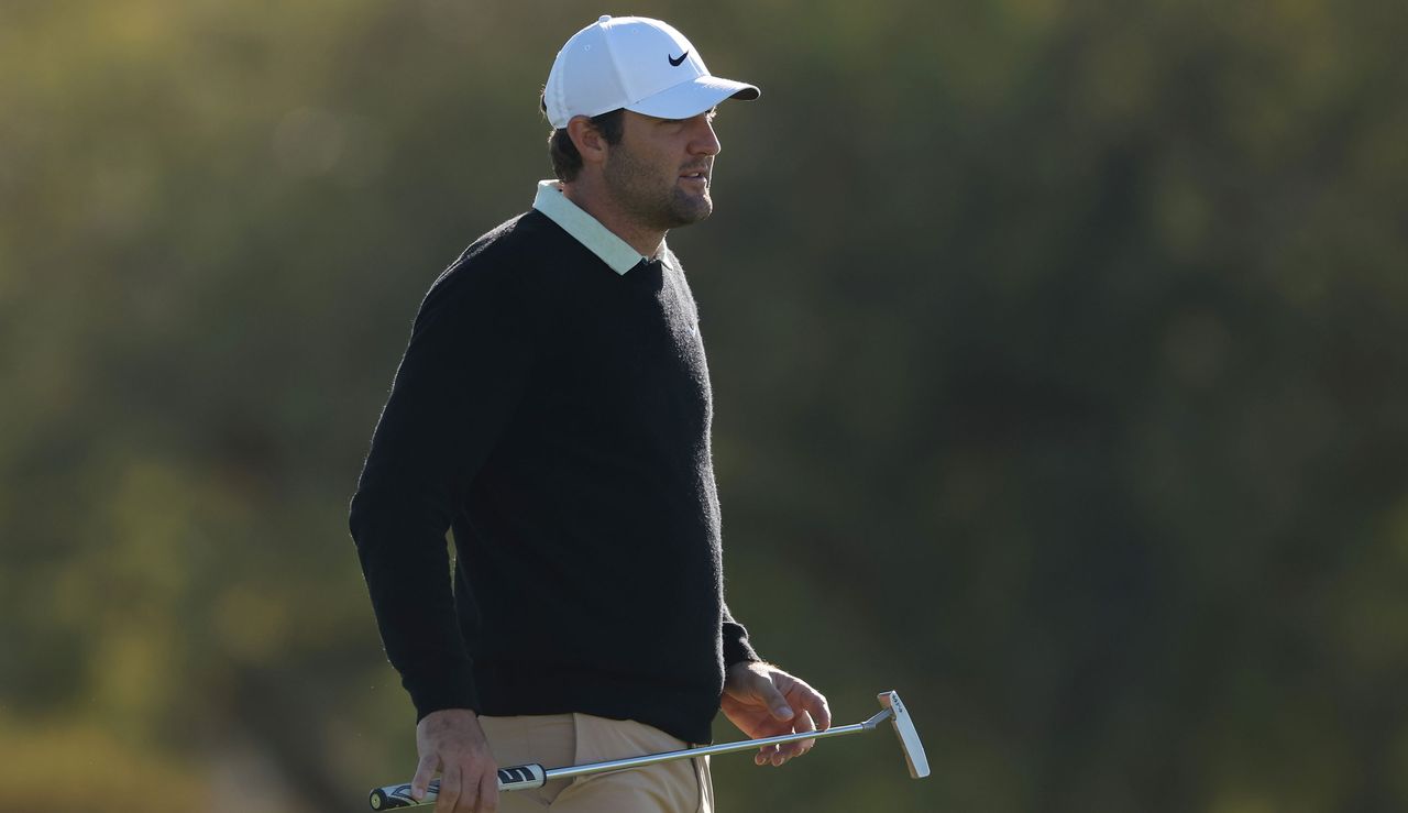 Scottie Scheffler waits to hit his putt on the green