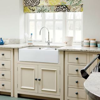 kitchen area with white wall and marbletop counter