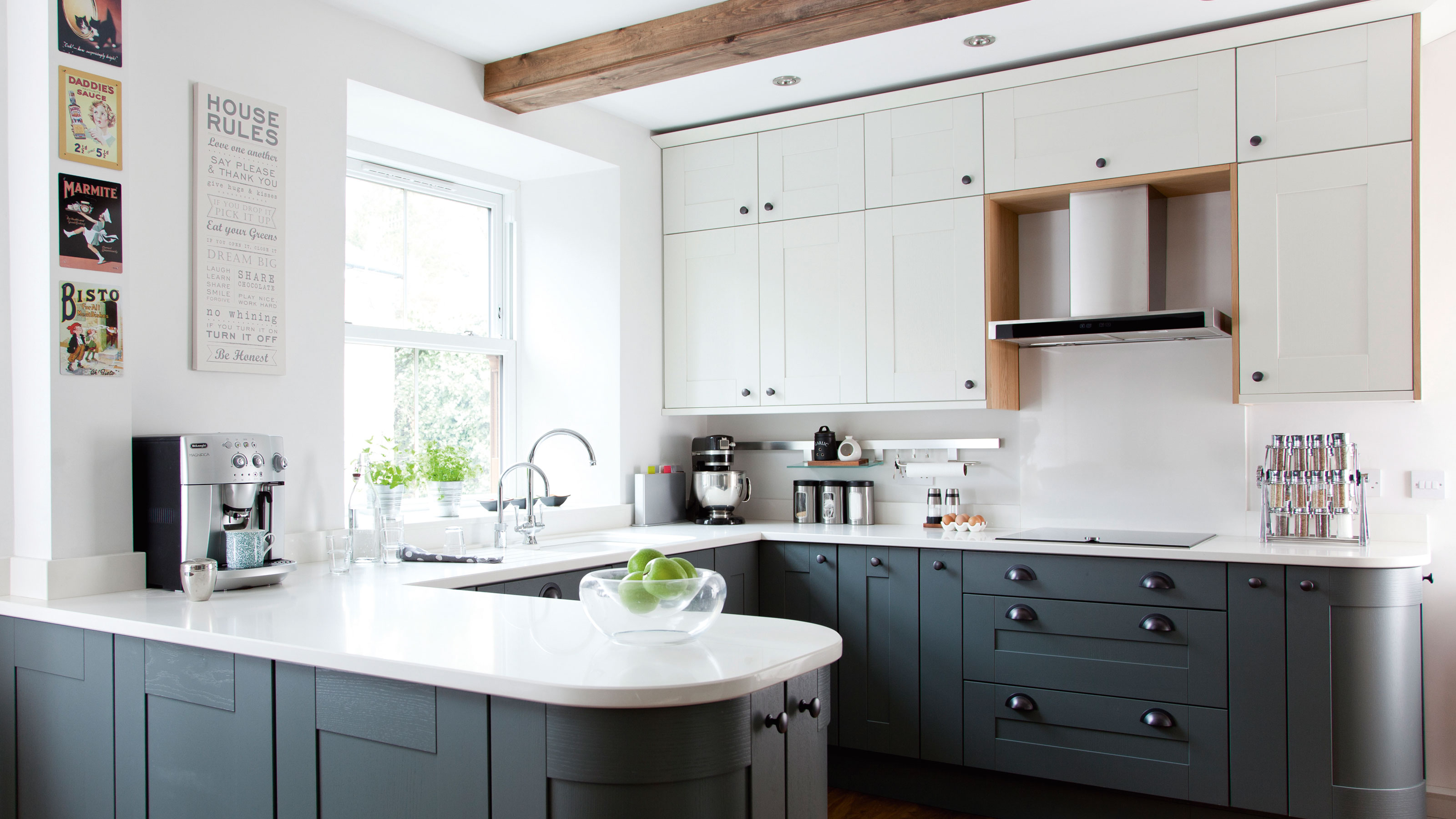Blue kitchen with white countertops and white cabinets