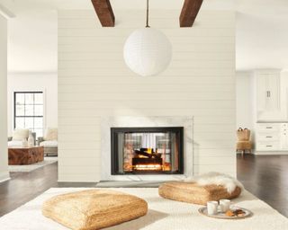 white open plan living space with modern fireplace and pendant light