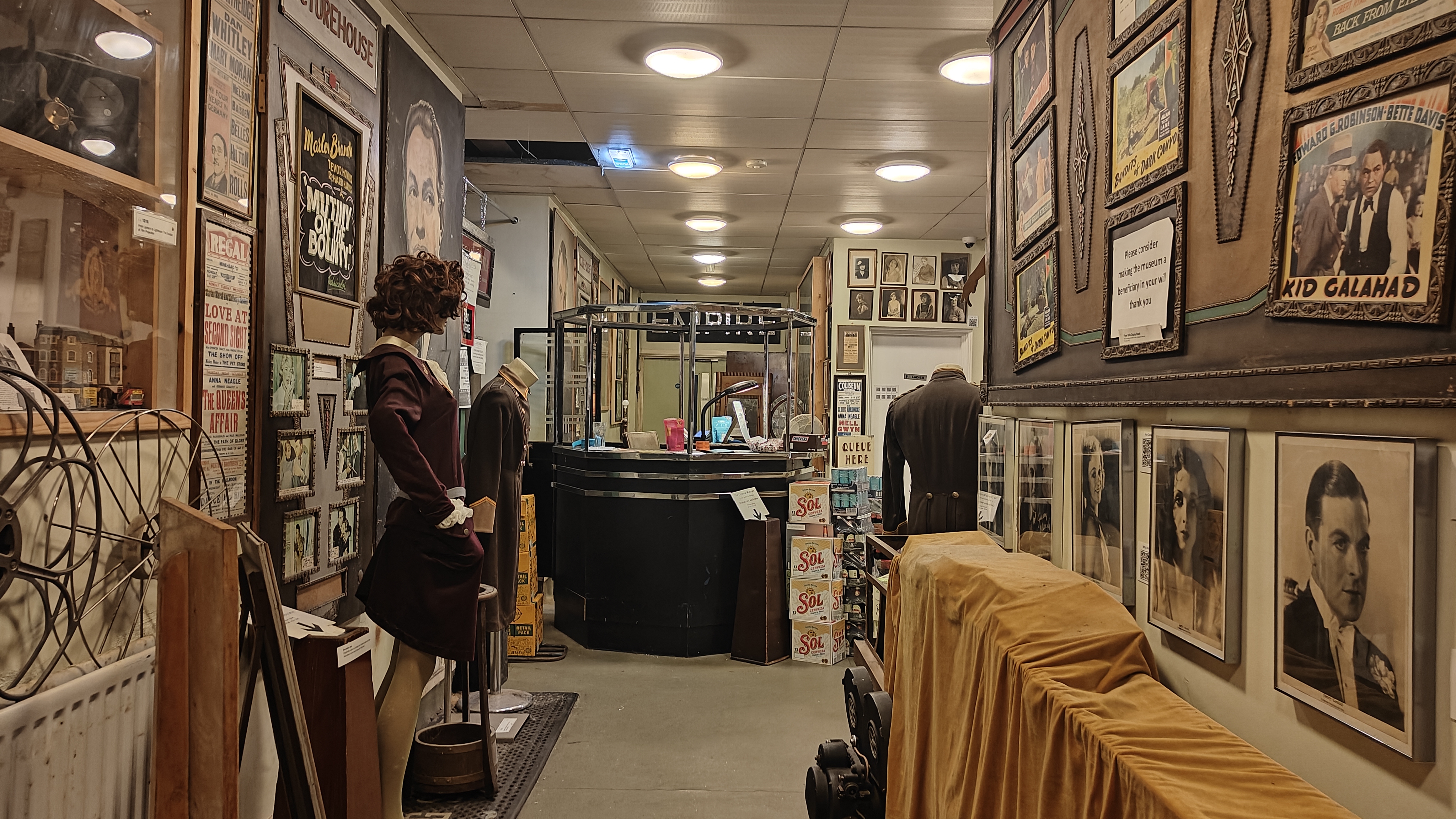 Interior image of the Cinema Museum, featuring portraits of old movie stars, old signage and a film booth.