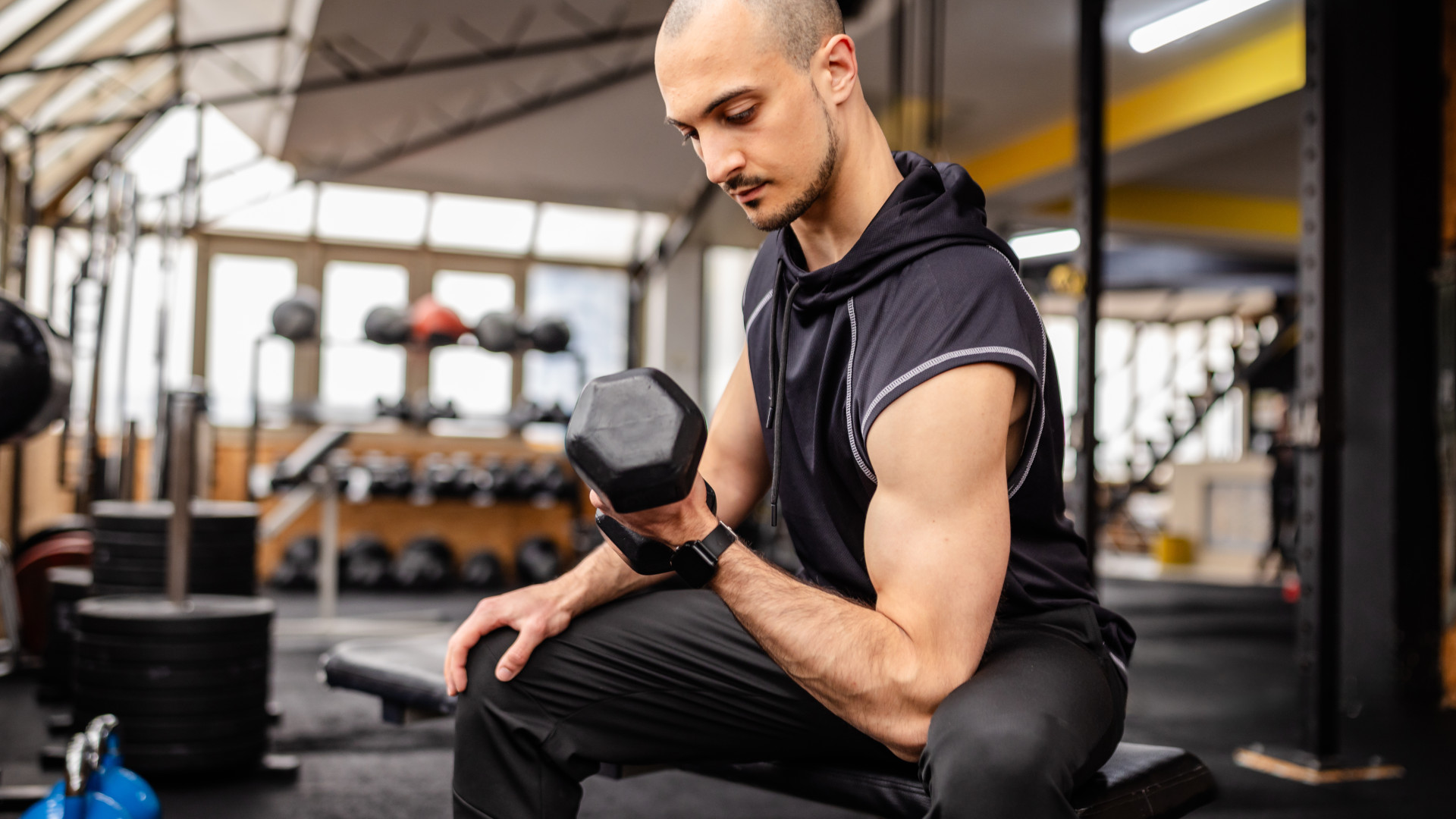 A man performing a concentration bicep curl
