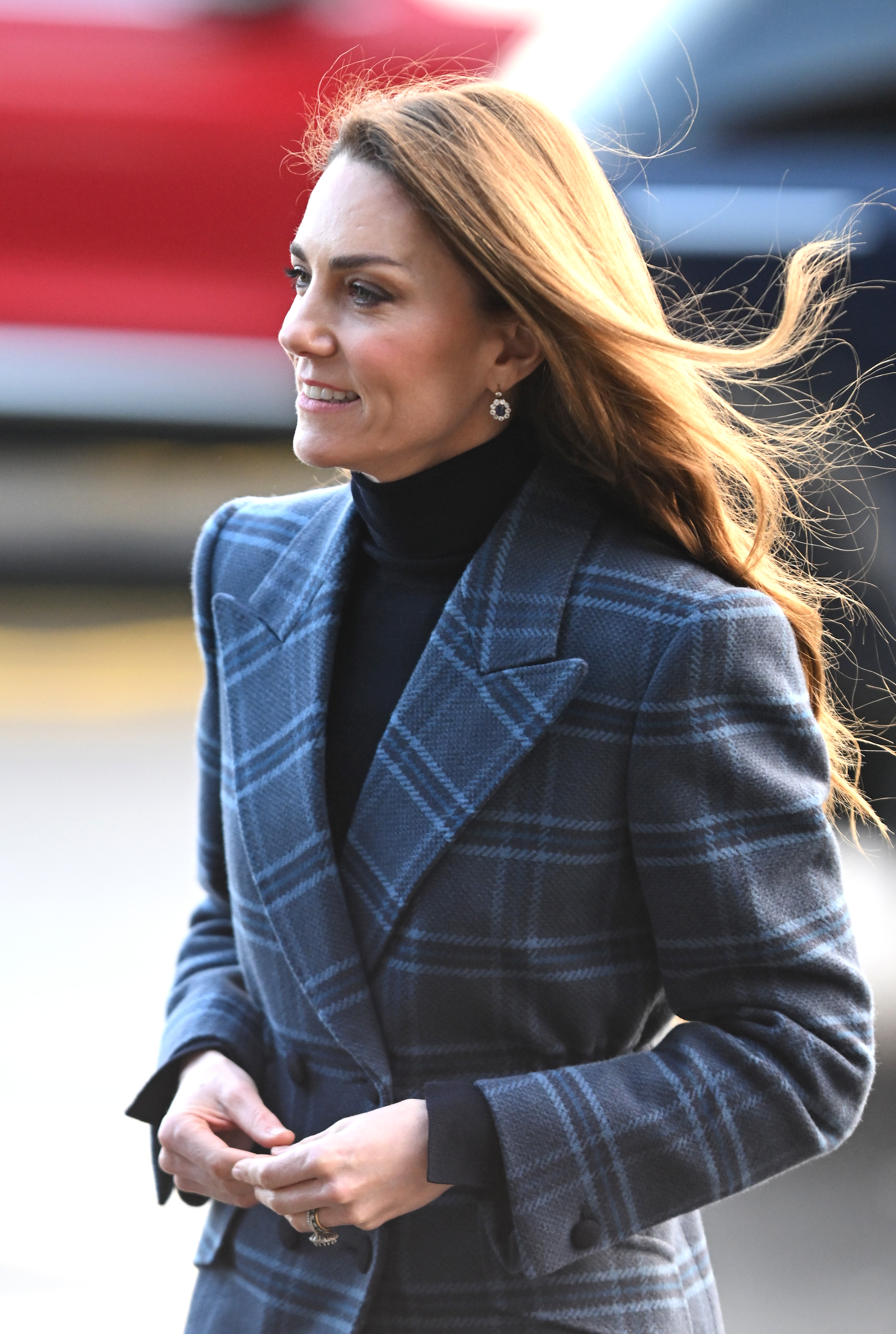 Princess Kate wearing a blue plaid coat and smiling
