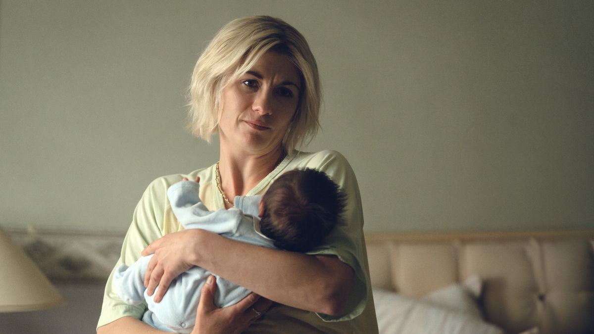 Susan holding her baby in Toxic Town.