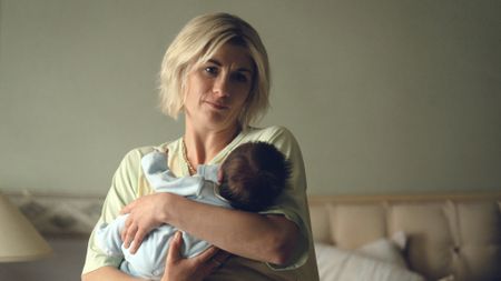 Susan holding her baby in Toxic Town.