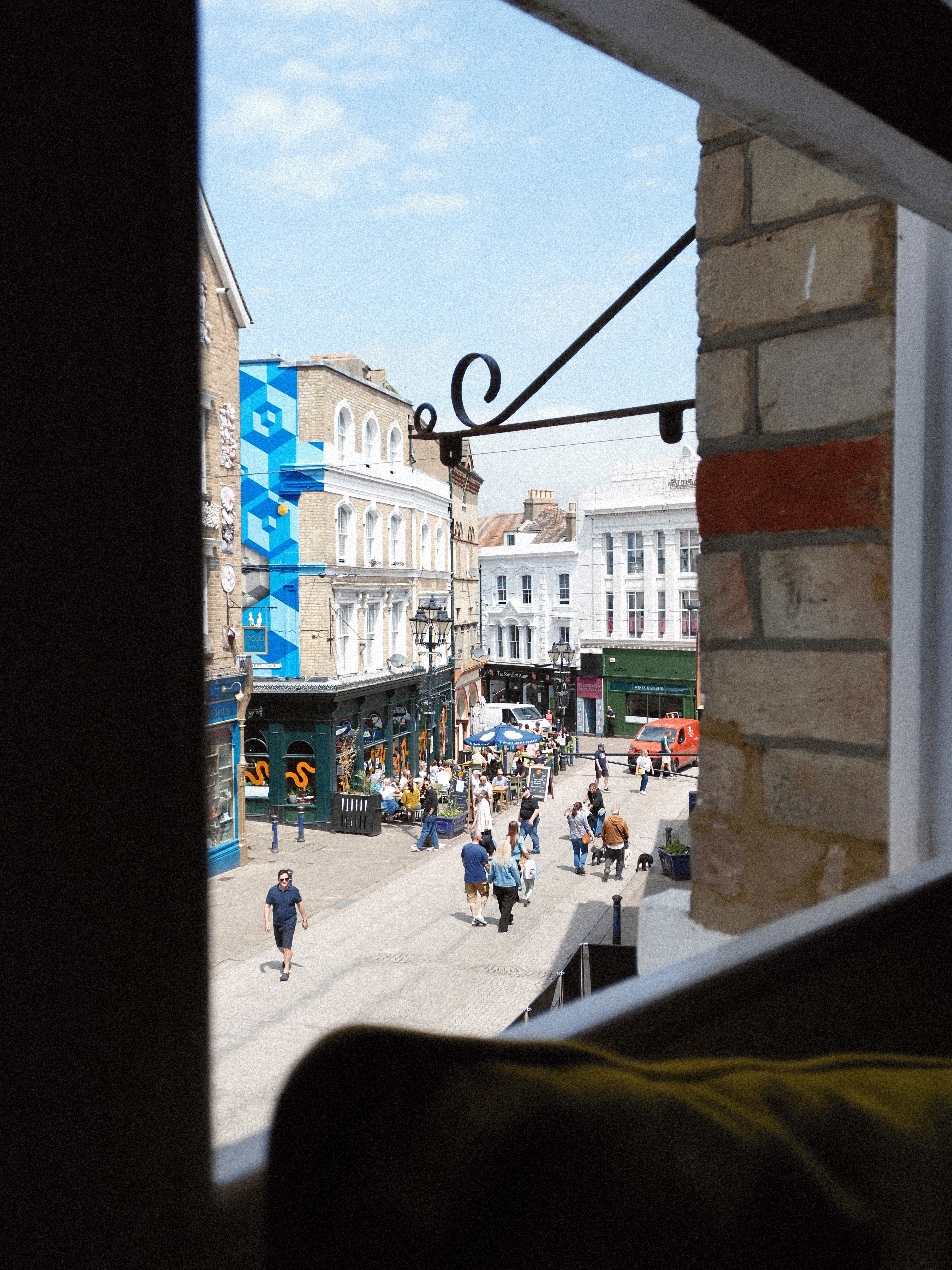 View out of a window of a busy shopping street