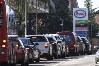 Cars queue outside a petrol station