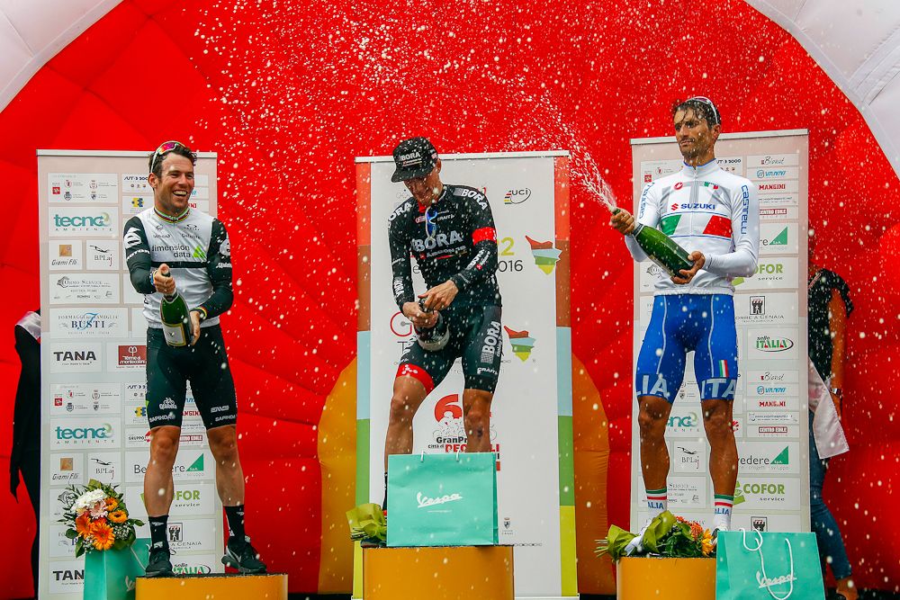 Sam Bennett leads the celbration on the stage 2 podium at the Giro della Toscana