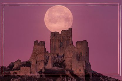 Full moon also known as Snow Moon sets behind Rocca Calascio castle in Calascio (AQ), Abruzzo, Italy, on February 17, 2022