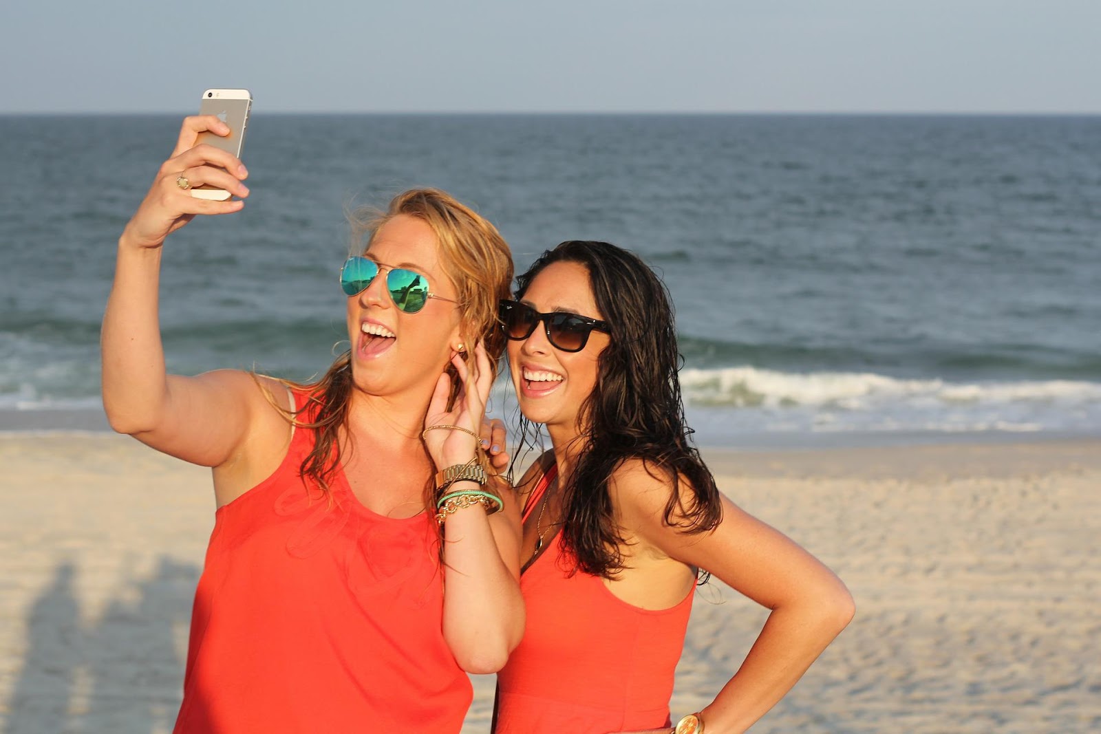 Two girls take a selfie on the beach