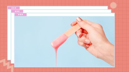 Cropped Image Of Hand Holding wooden spatula with pink Hair Removal Wax dripping of it on a light blue background