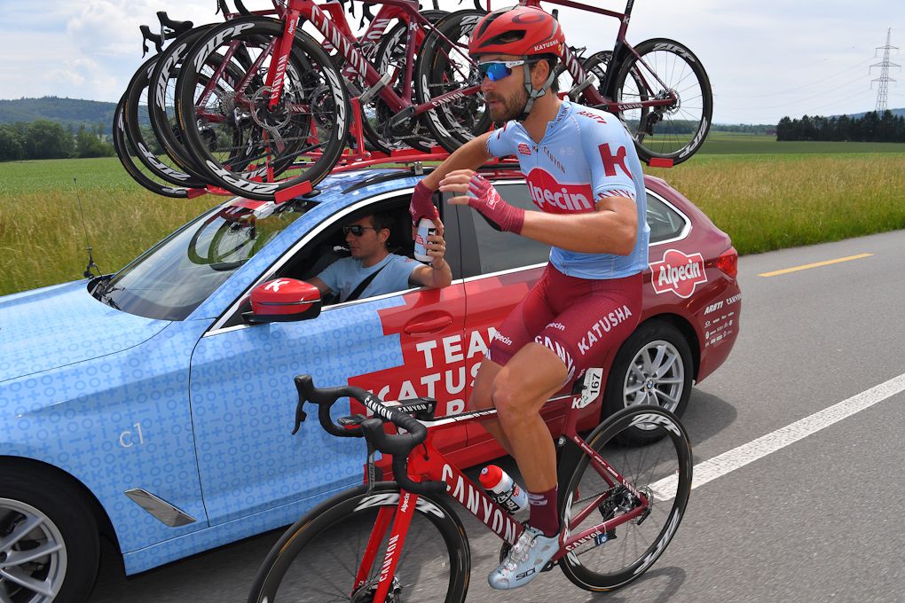 Rick Zabel fetches a beverage from the Katusha-Alpecin team car