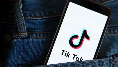 In this photo illustration, a Tik Tok logo seen displayed on a smartphone.