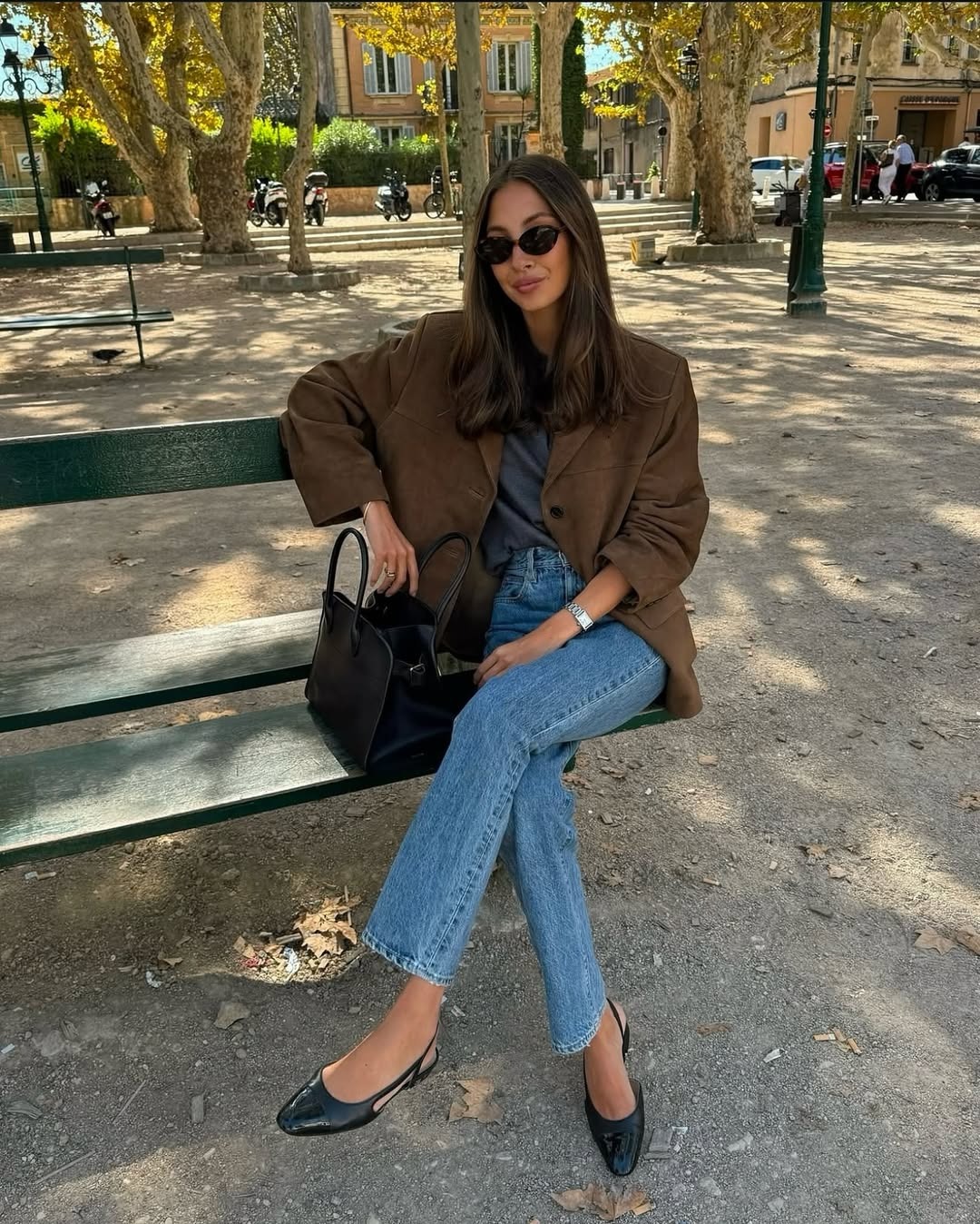 Woman in jeans and brown blazer