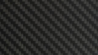 Close-Up of Black Carbon Fibre Surface - stock photoA detailed view of carbon fibre weave texture. Modern, lightweight, and strong, commonly used in high-tech manufacturing and motorsport.