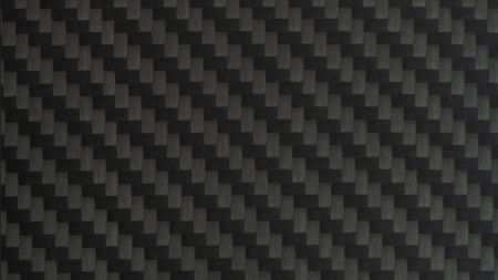 Close-Up of Black Carbon Fibre Surface - stock photoA detailed view of carbon fibre weave texture. Modern, lightweight, and strong, commonly used in high-tech manufacturing and motorsport.