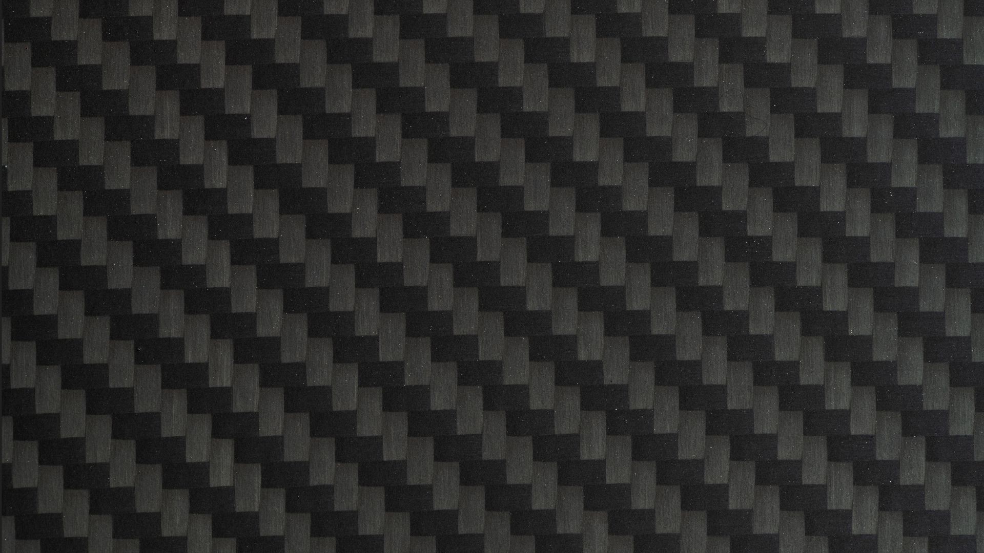 Close-Up of Black Carbon Fibre Surface - stock photoA detailed view of carbon fibre weave texture. Modern, lightweight, and strong, commonly used in high-tech manufacturing and motorsport.