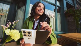 A woman using the Motorola Razr Fold with the Moto Pen Ultra