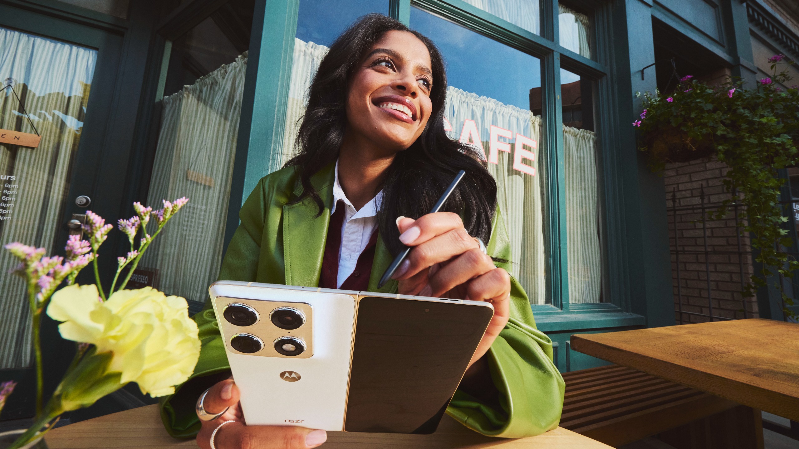 A woman using the Motorola Razr Fold with the Moto Pen Ultra