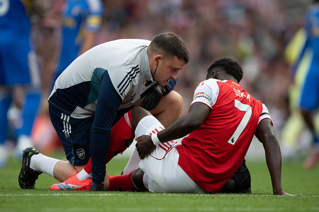 Bukayo Saka receives treatment on his hamstring