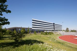 view of the adidas HQ building in the distance, with view of a running track to the right