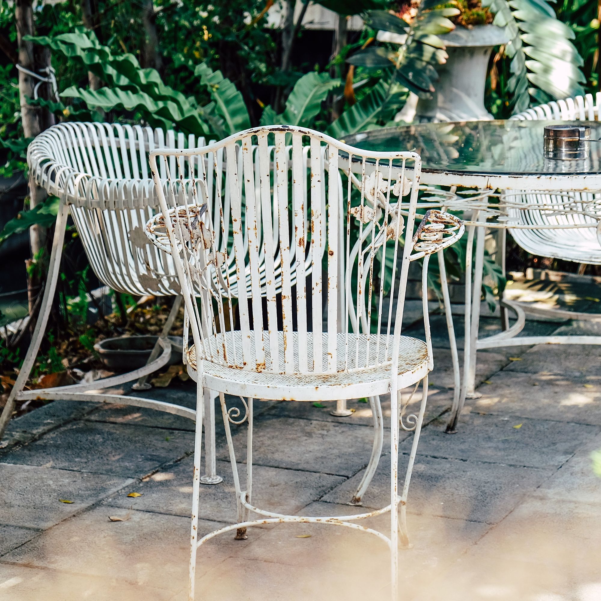 white garden chairs going rusty