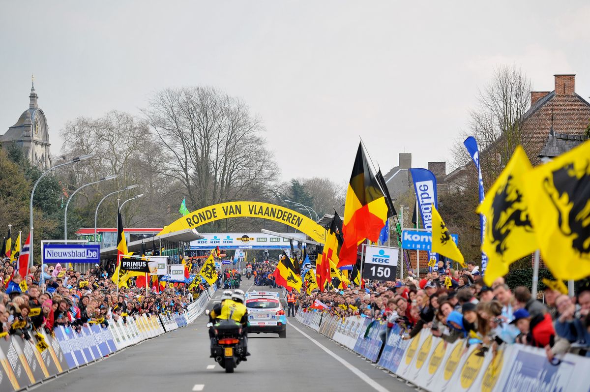 The finish line of the Tour of Flanders is packed with fans and flag